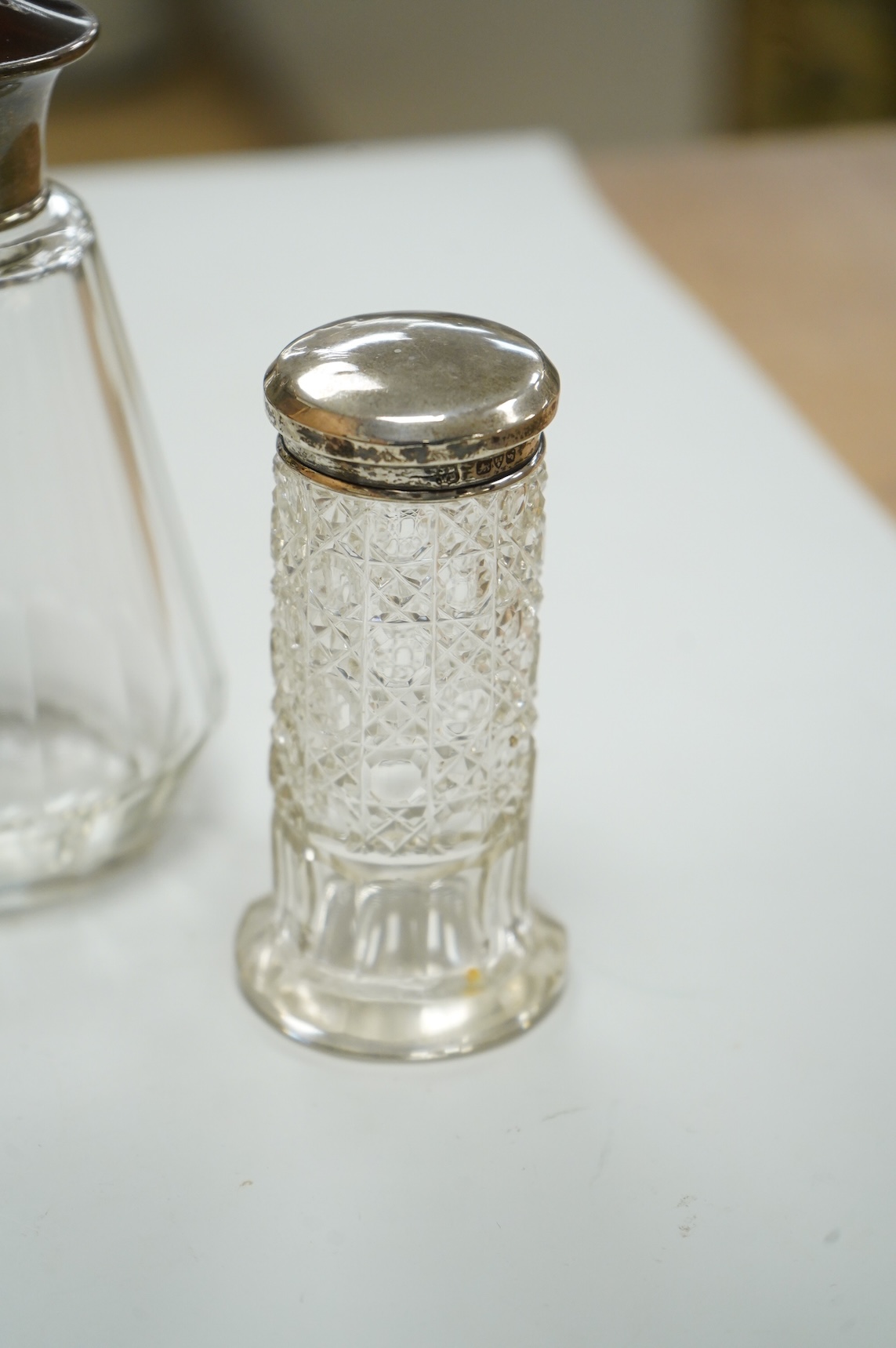 Three George V silver and tortoiseshell mounted glass toilet jars, Adie Brothers, Birmingham, 1925 & 1927, together with three other silver mounted glass toilet jars.